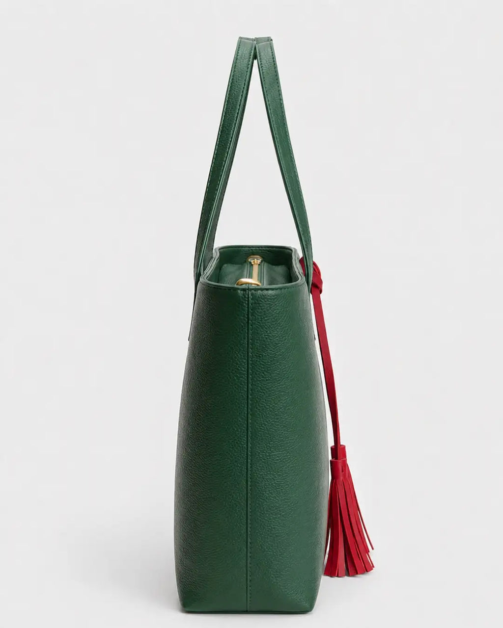 Emerald green leather tote bag with double shoulder straps and red decorative tassels