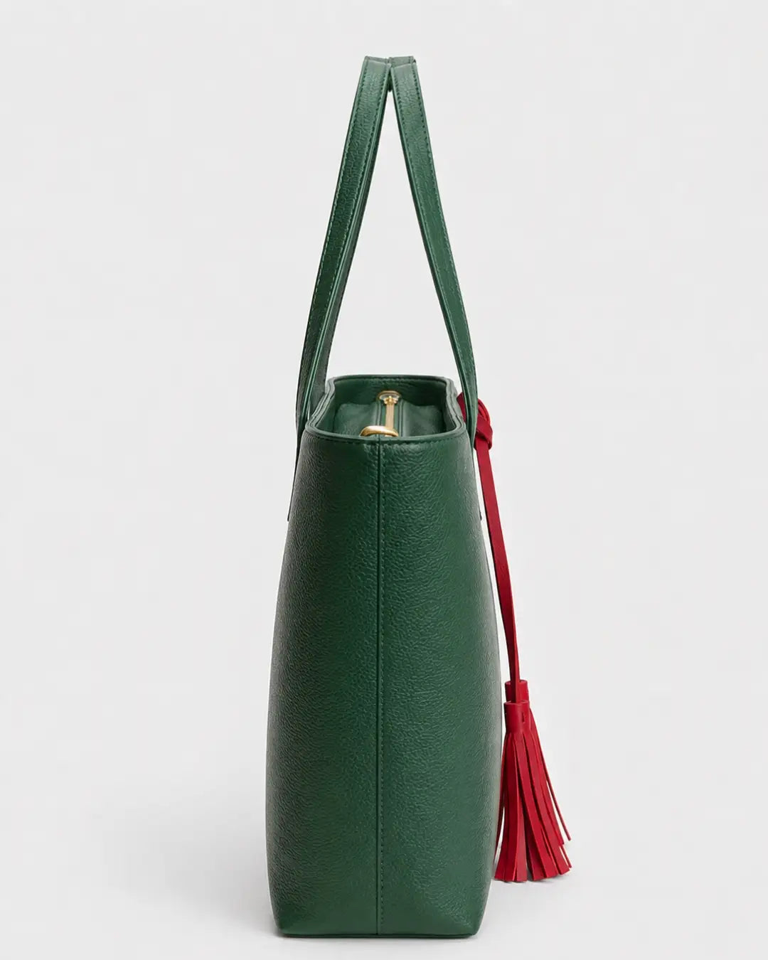 Emerald green leather tote bag with double shoulder straps and red decorative tassels