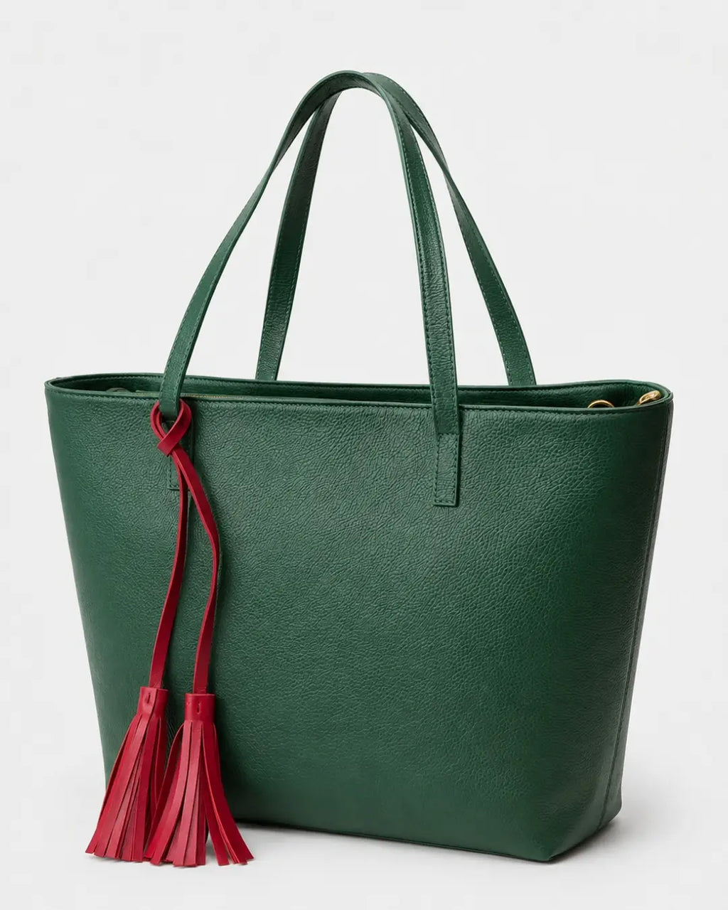 Emerald green leather tote bag with double shoulder straps and red decorative tassels